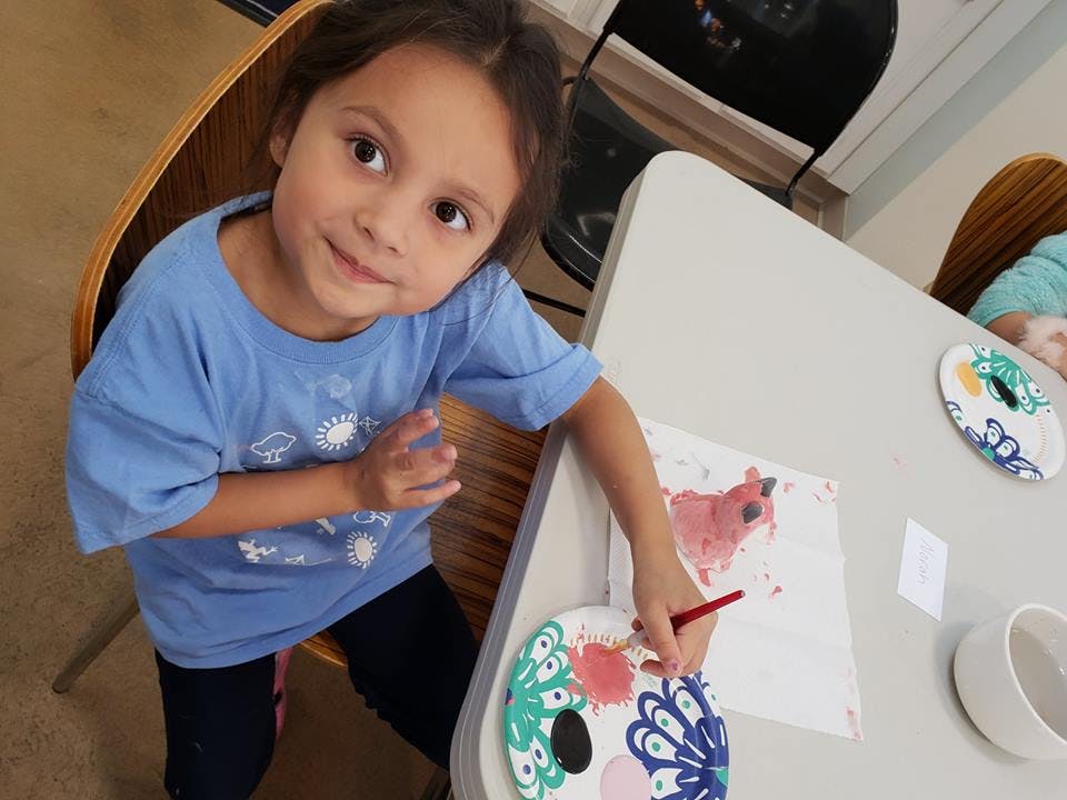 Child painting at a table