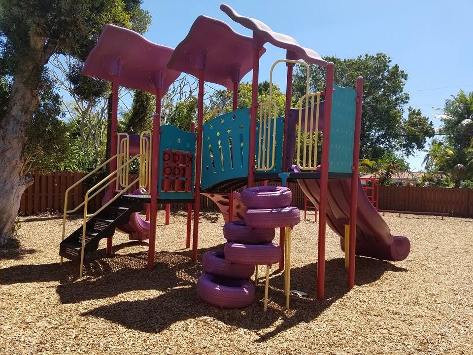 Playground structure with slides and climbing elements