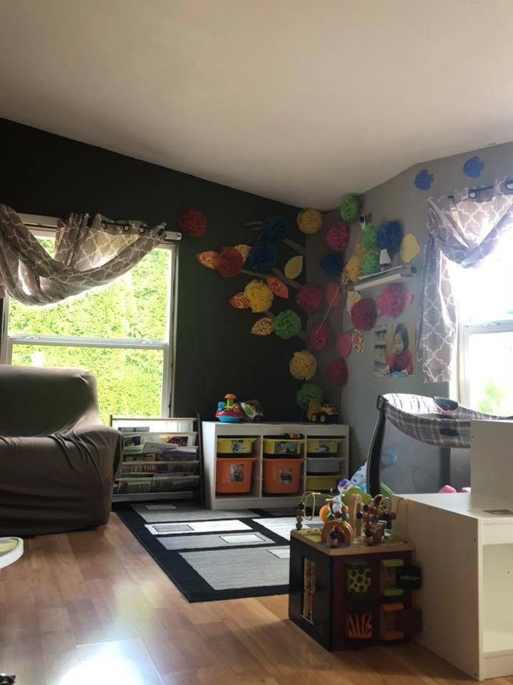 Playroom with colorful decorations on the wall and toy storage