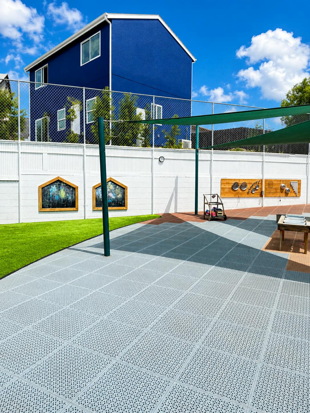 Outdoor children play area with sensory stations and play equipment