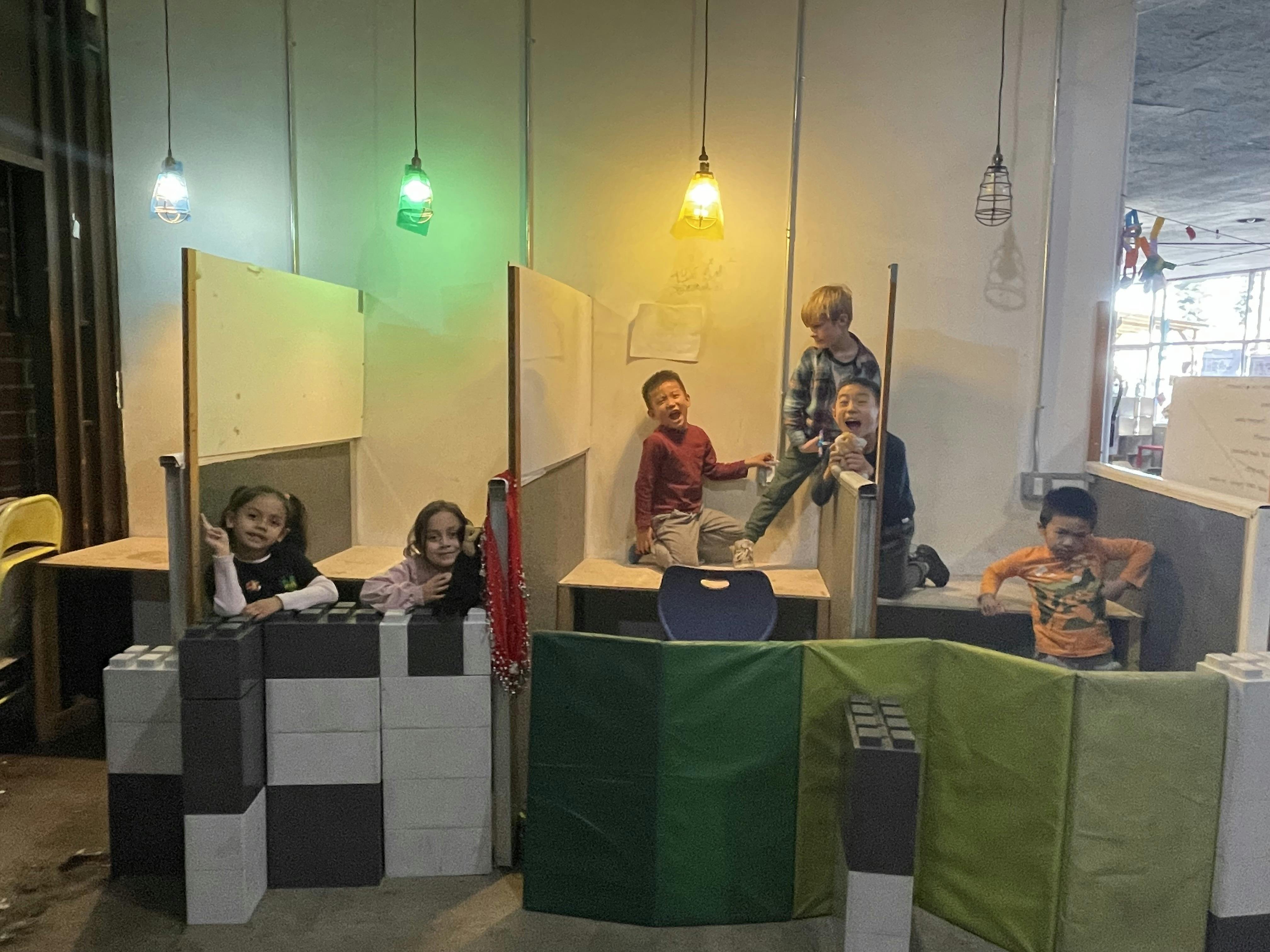 Children playing in a room with colorful lights