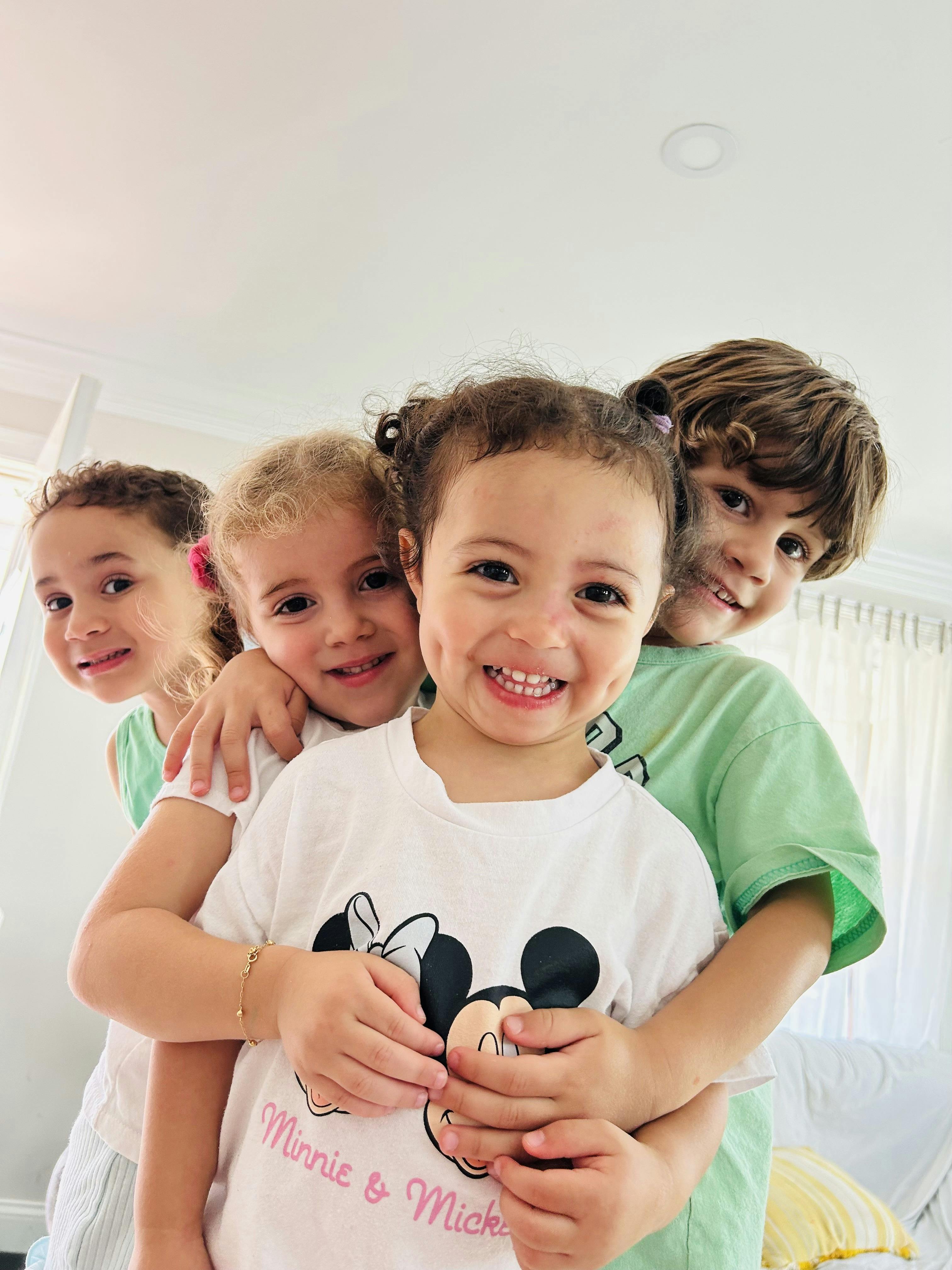 Four children smiling and looking at the camera
