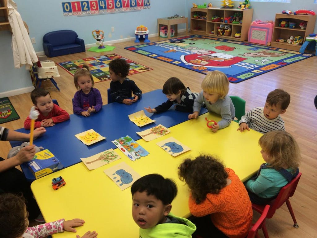 Children sitting at tables in a classroom