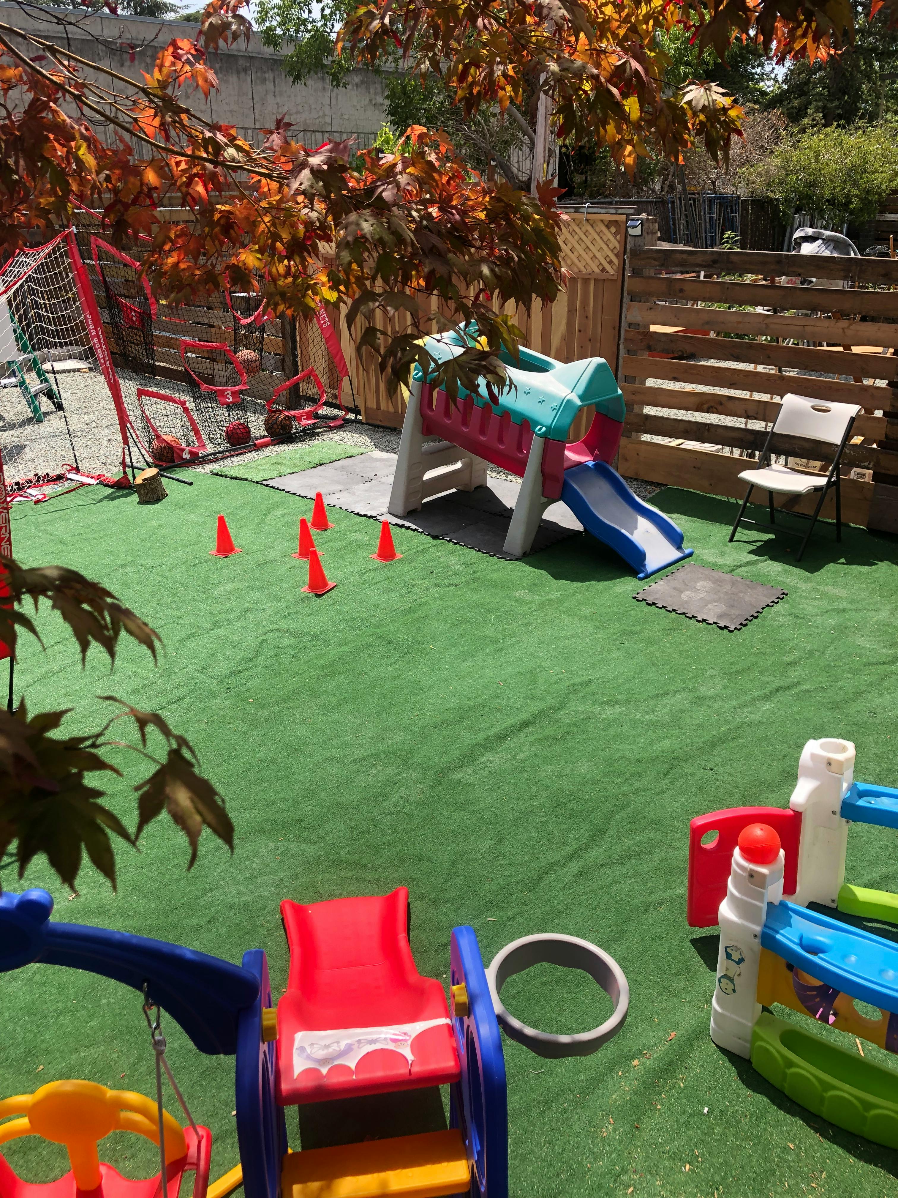 Playground with artificial turf, slide, and soccer goal