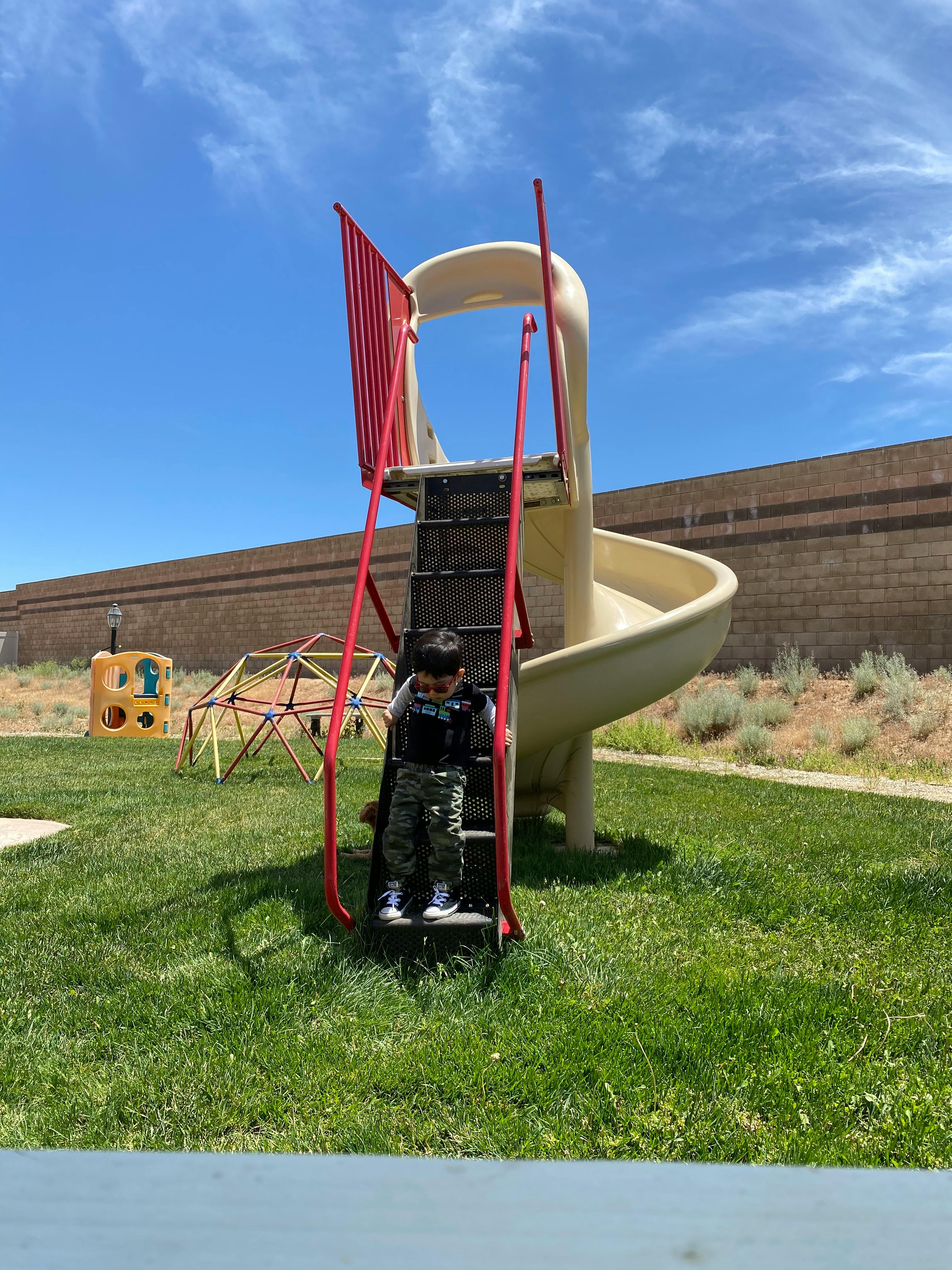 Child climbing stairs of a playground slide