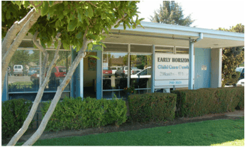Building with large windows and a sign that reads "Early Horizon Child Care Center"