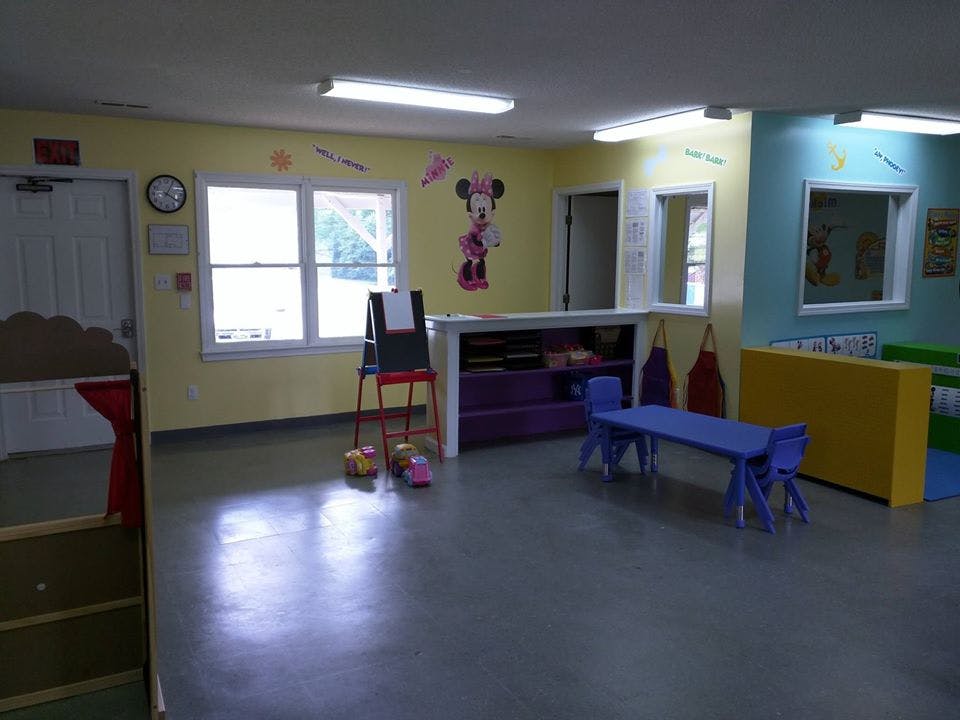 Empty classroom with small tables and chairs