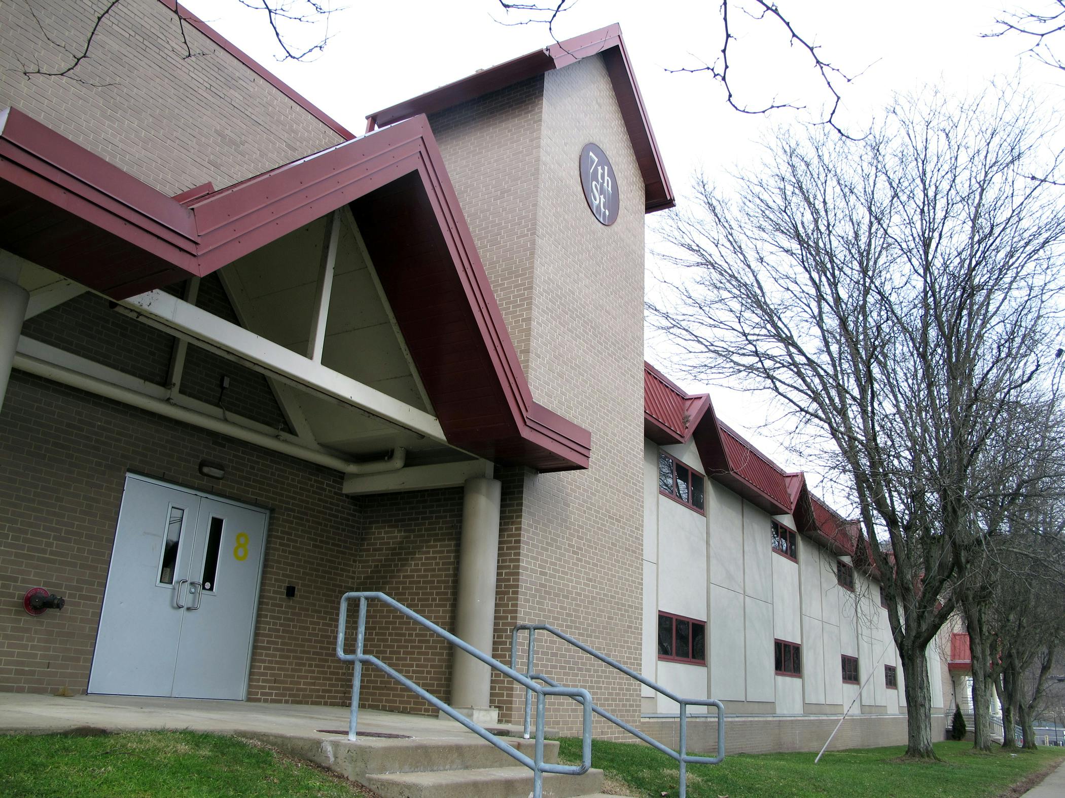 Exterior of a building with a red roof and light-colored walls