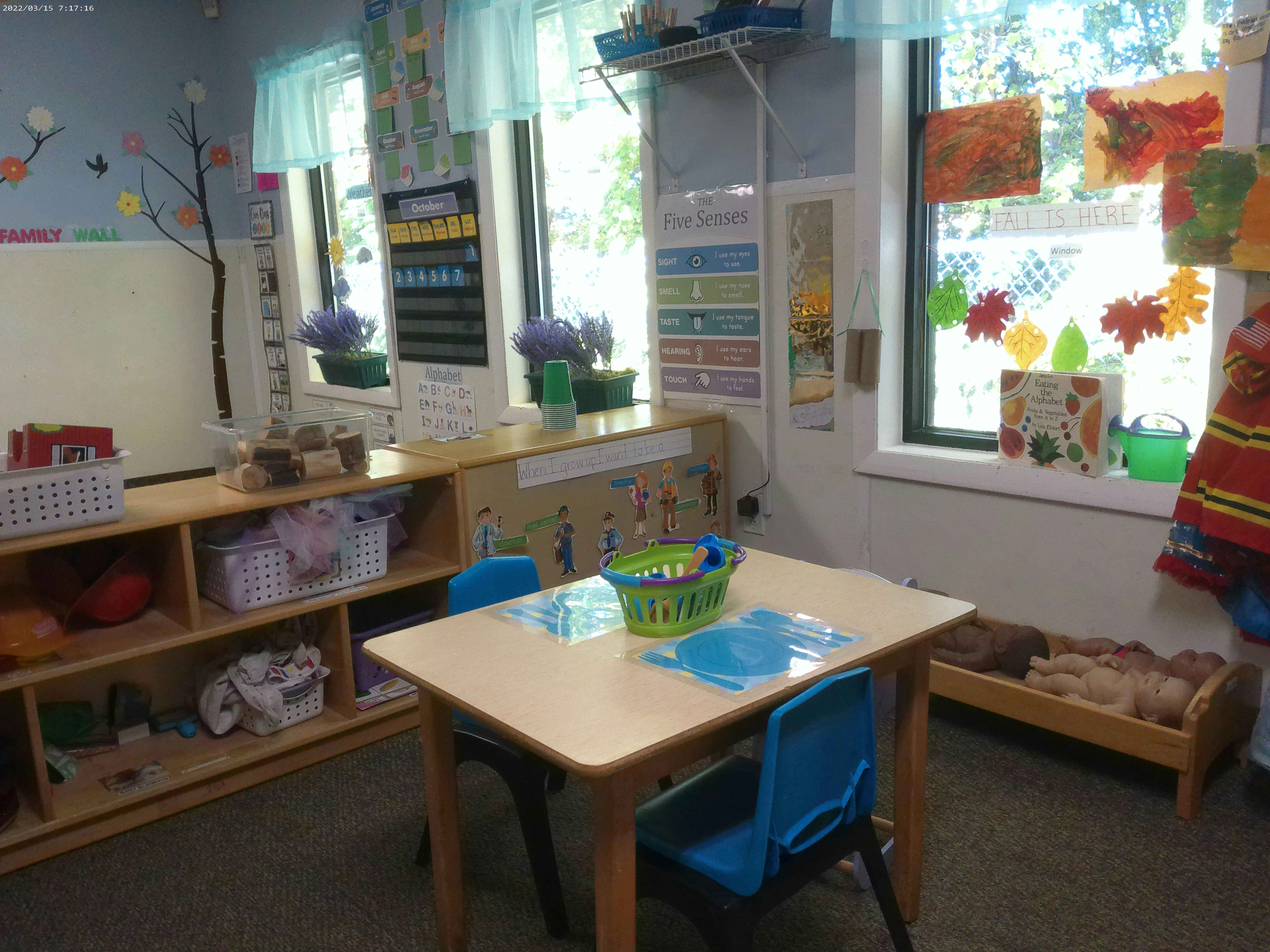 Classroom with small table and chairs, shelves, and windows