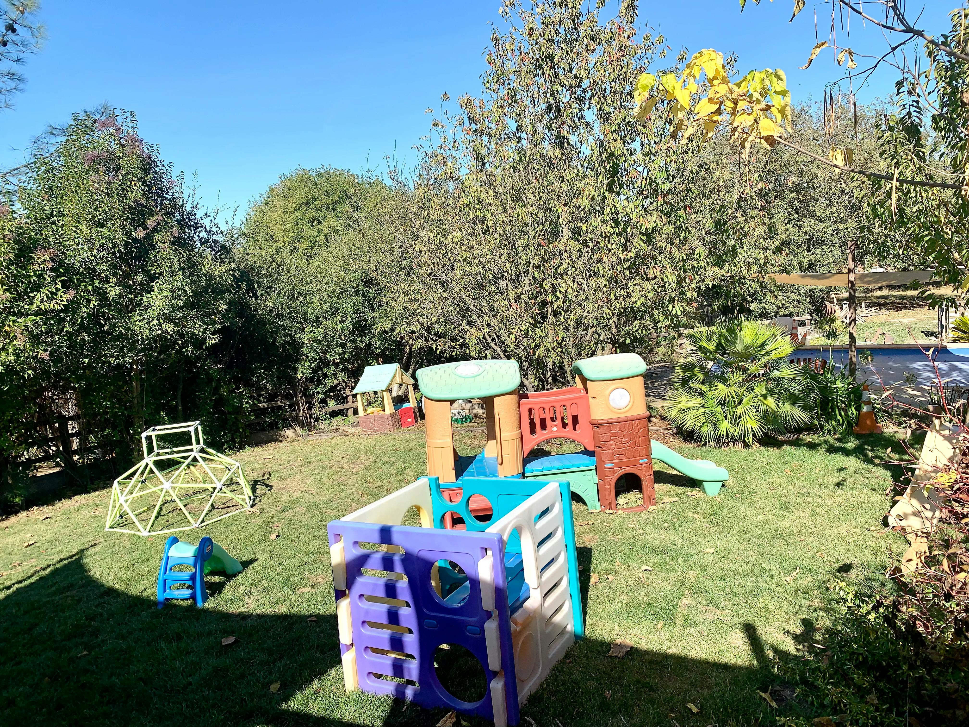 Playground with multiple colorful play structures on grass