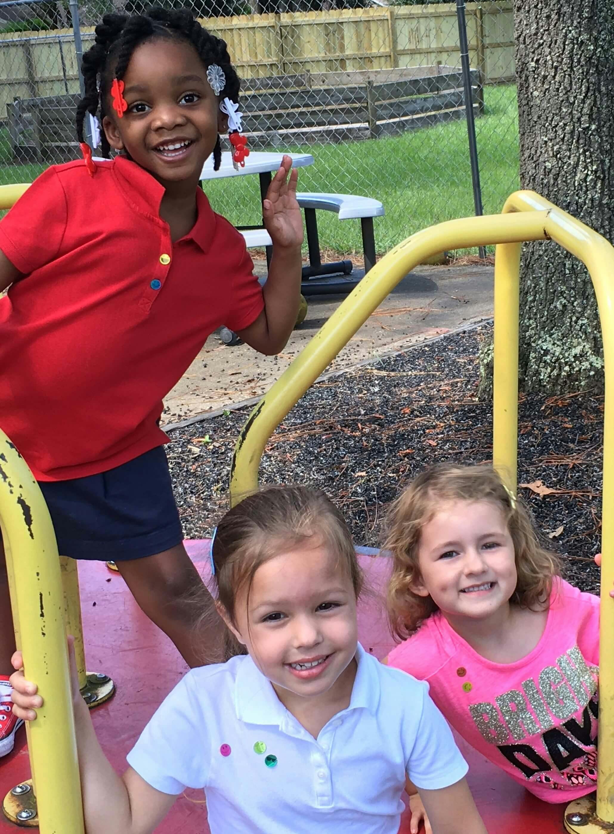 Three children on playground equipment