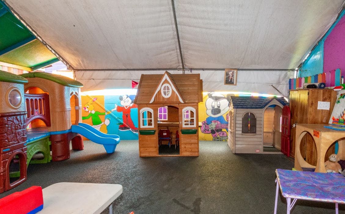 Indoor play area with playhouses and a slide