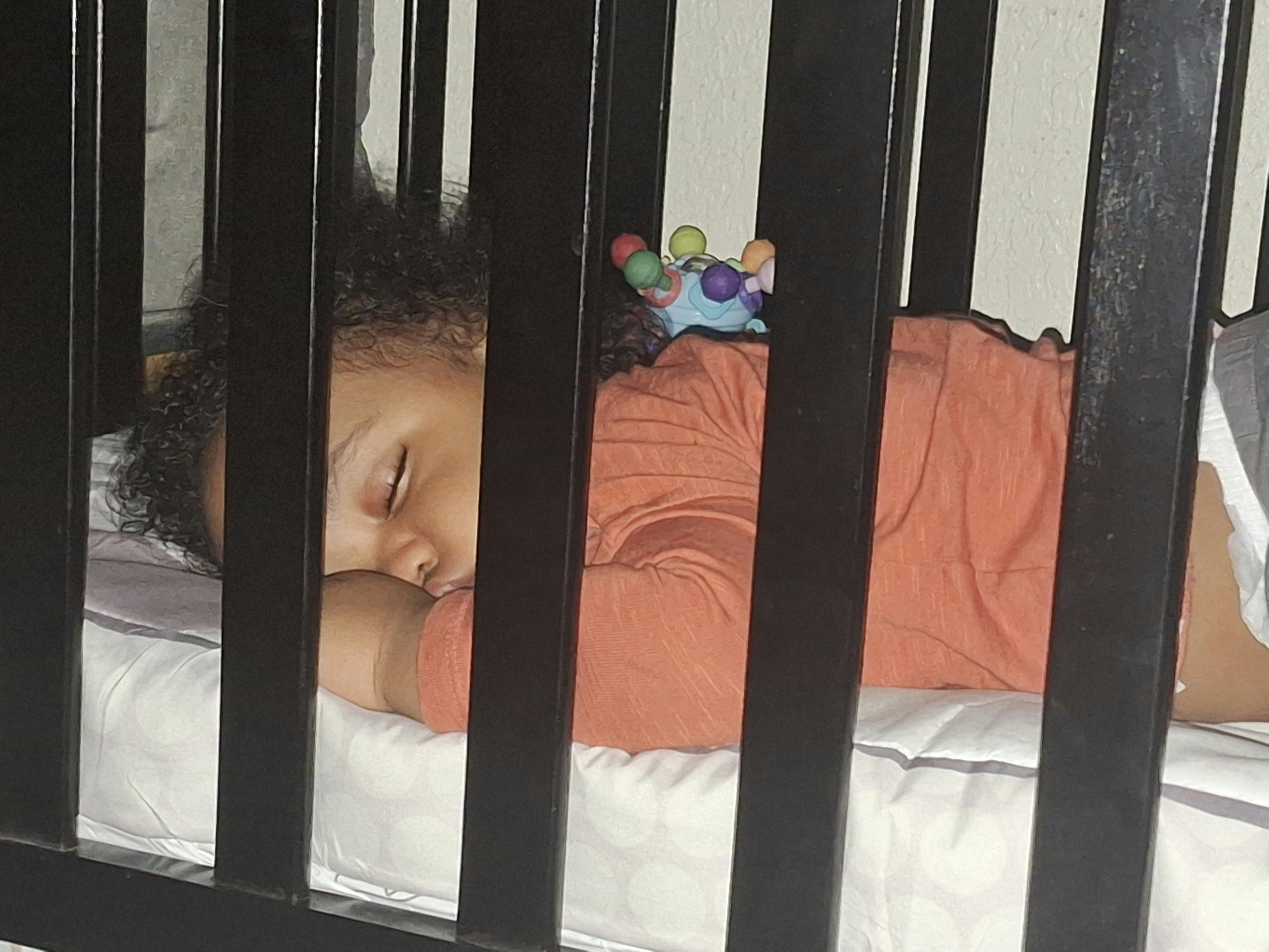 Child sleeping in a crib