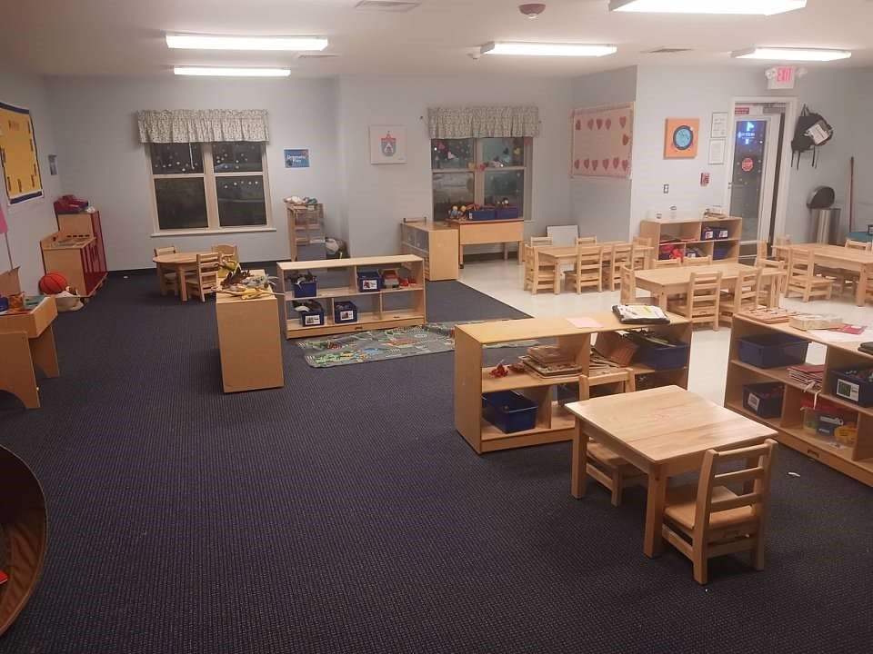 Empty classroom with small tables and chairs
