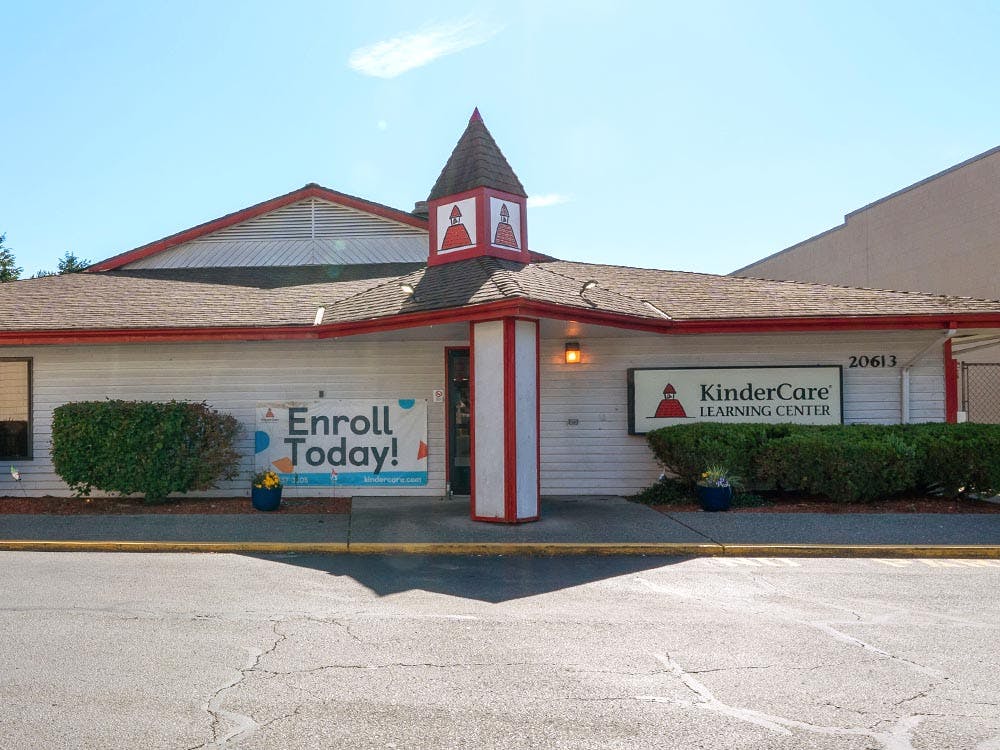 KinderCare Learning Center building with "Enroll Today!" banner