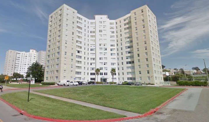 Large white apartment building with a curved facade