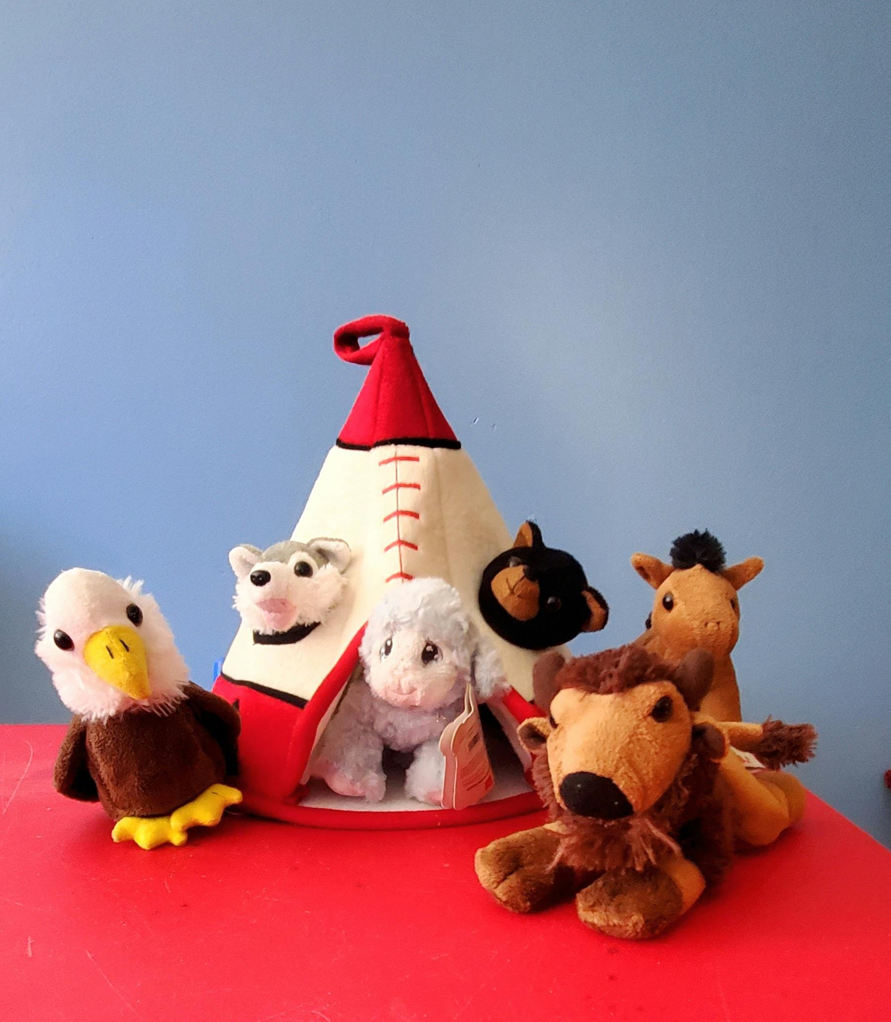 Stuffed animals around a small teepee