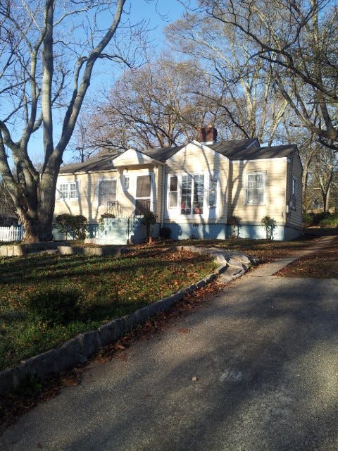 Single-story house with a bay window and bare trees