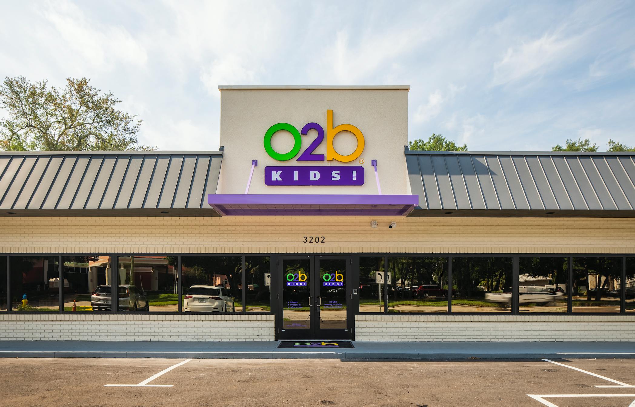 Exterior of a building with the colorful 'o2b KIDS!' sign above the entrance