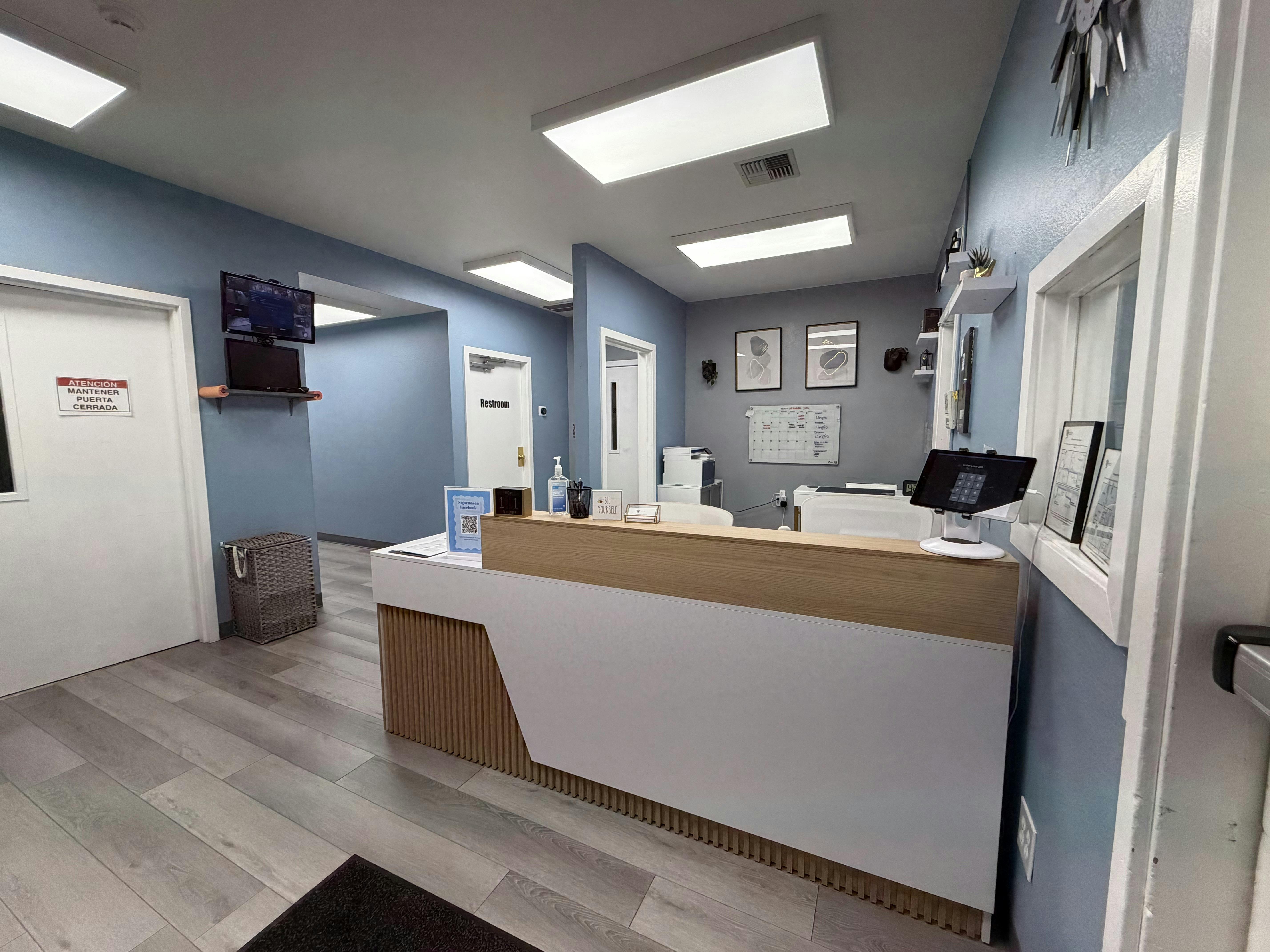 Reception desk in a waiting area with doors and office decor