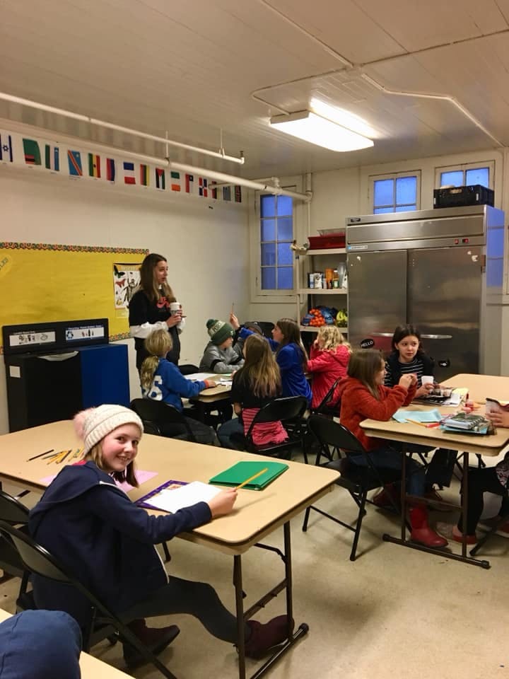 Adult and children in a classroom