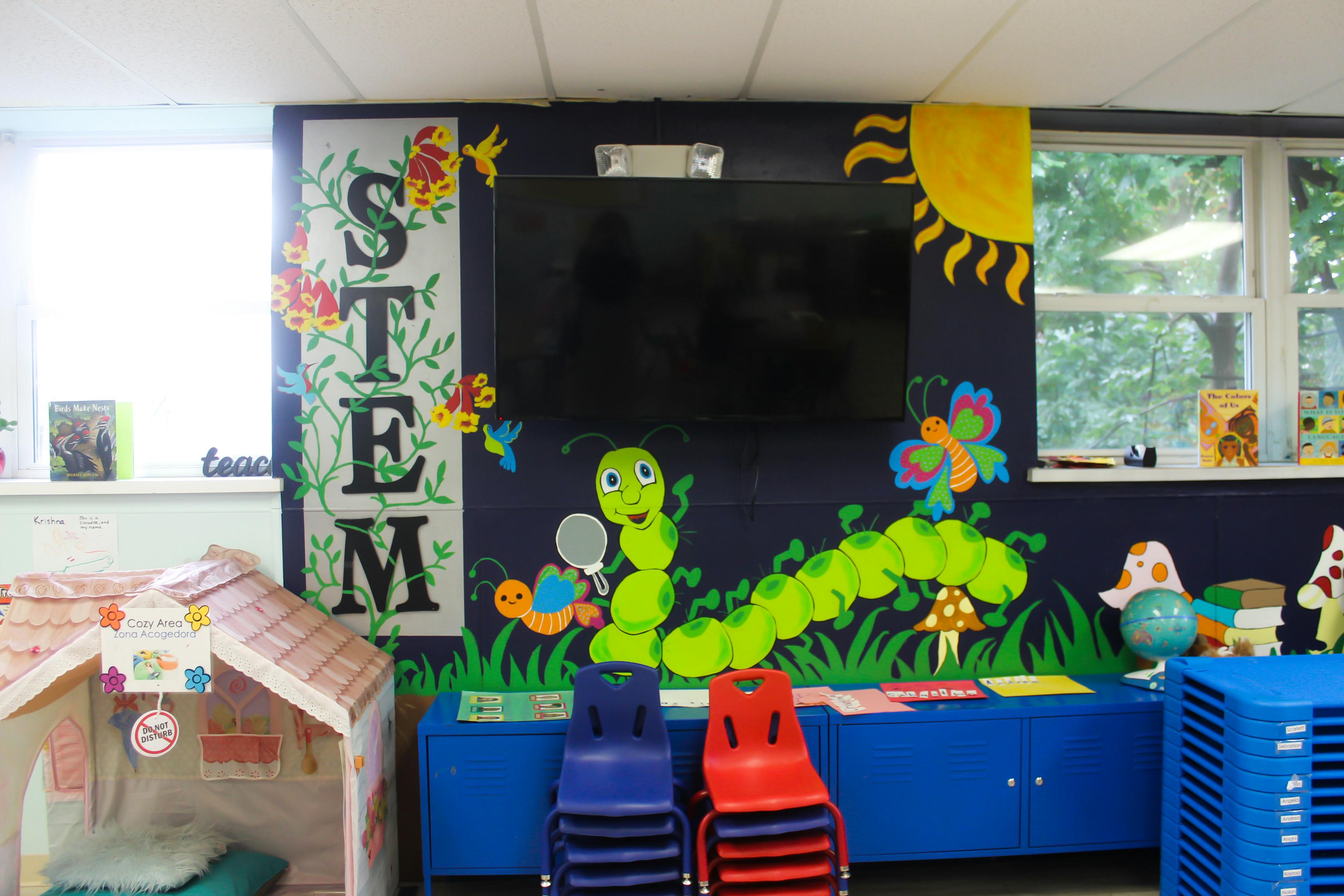 Classroom wall with STEM sign and caterpillar mural