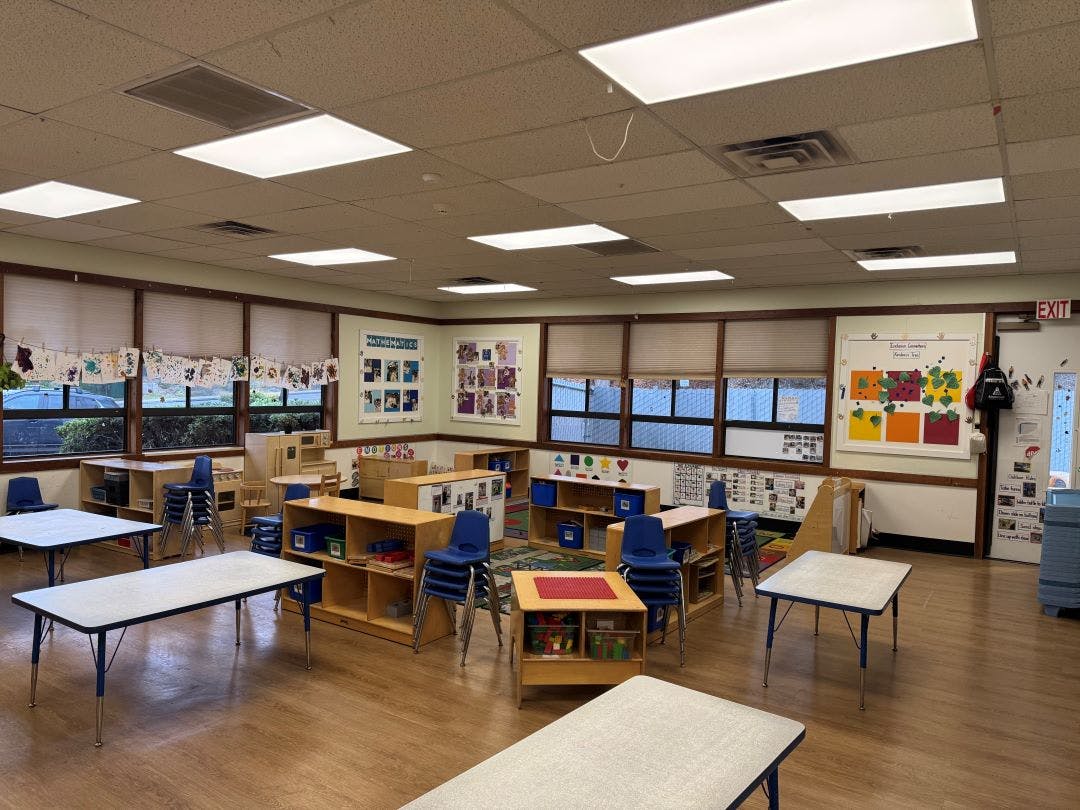 Empty classroom with small tables and chairs