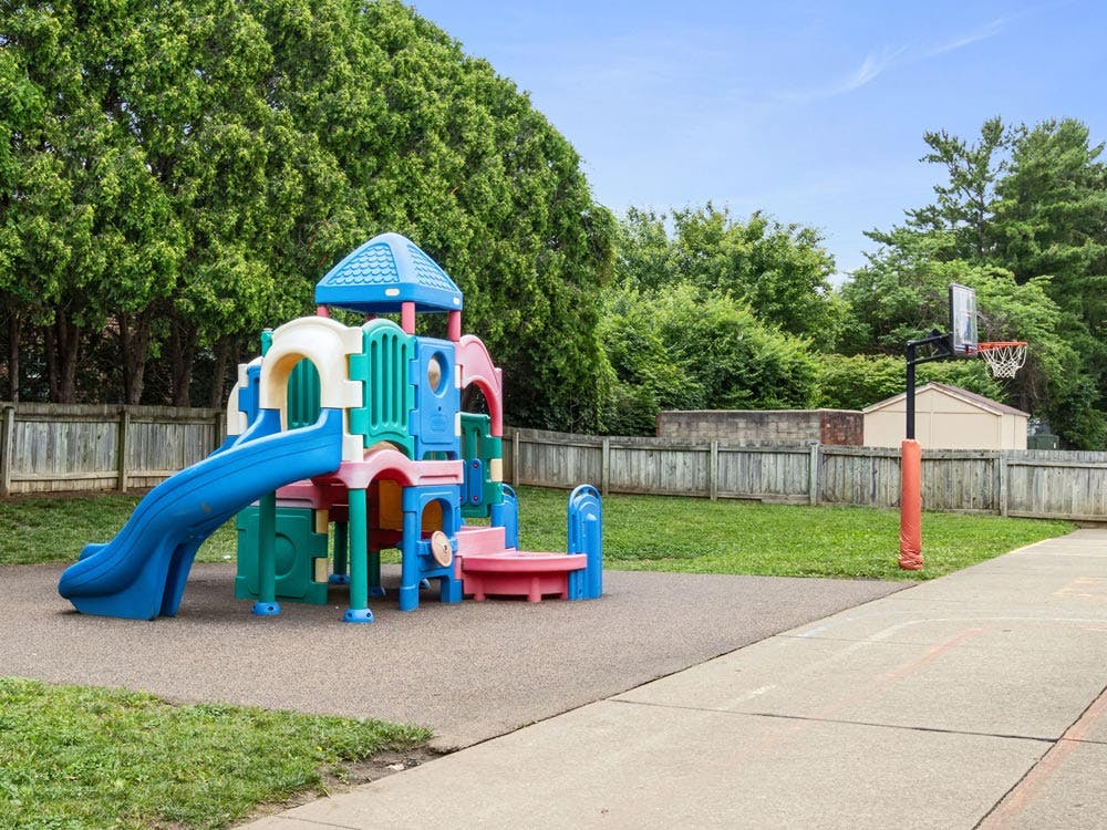 Playground equipment with a slide and a basketball hoop