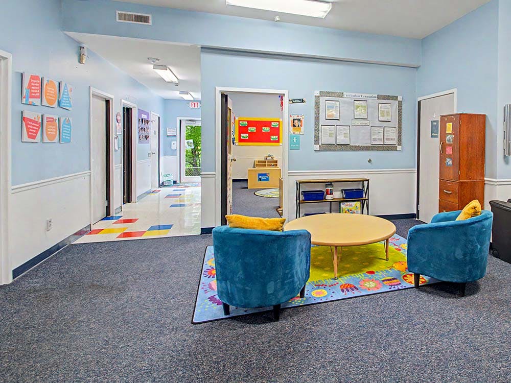 Lobby area with two blue chairs and a circular table