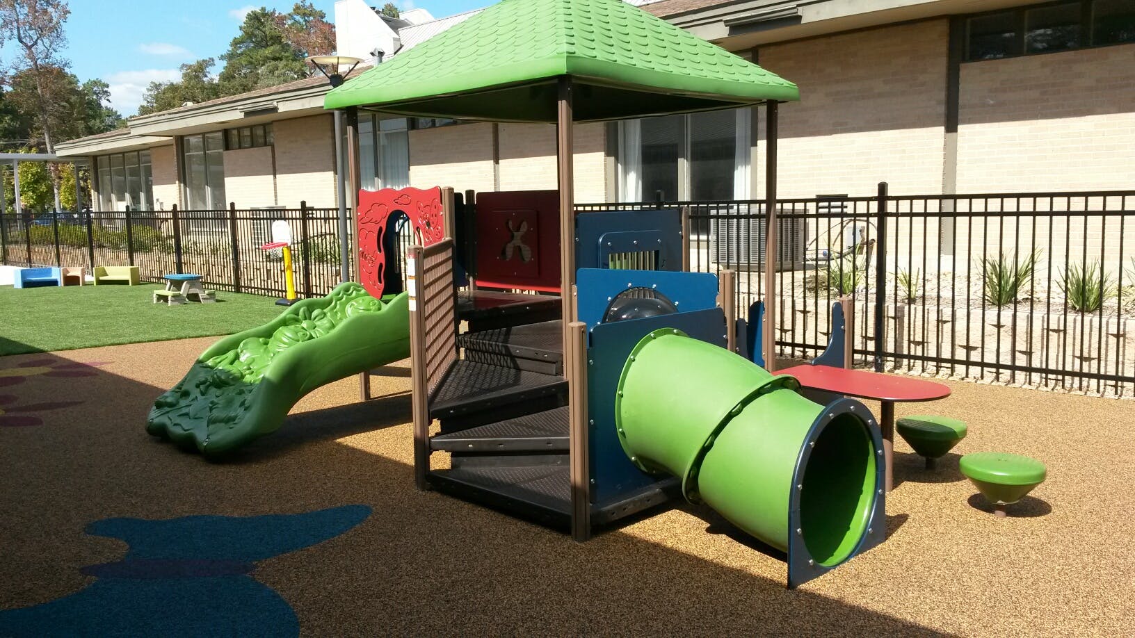 Playground with green slide and tunnel