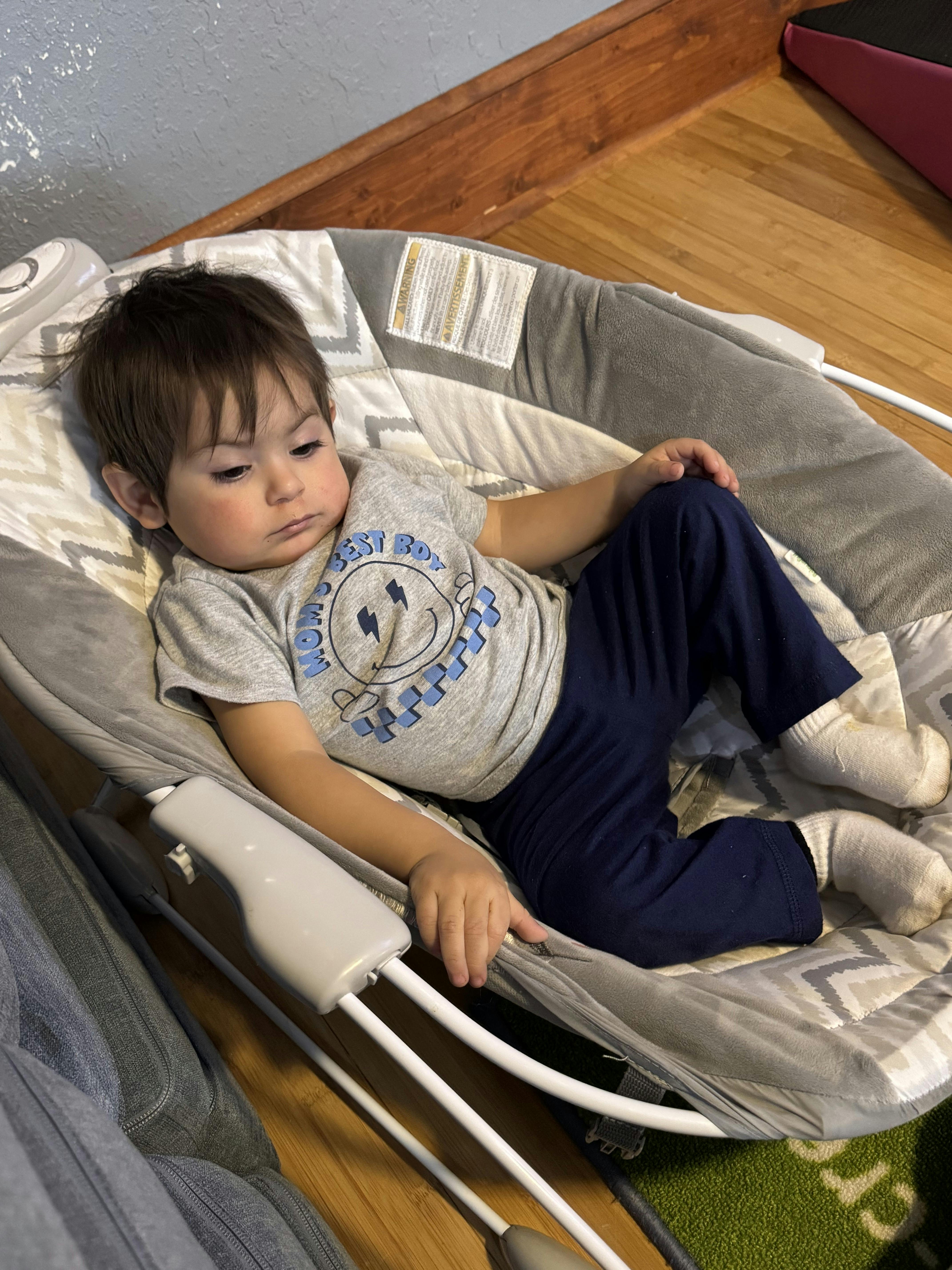 Child sitting in a baby bouncer