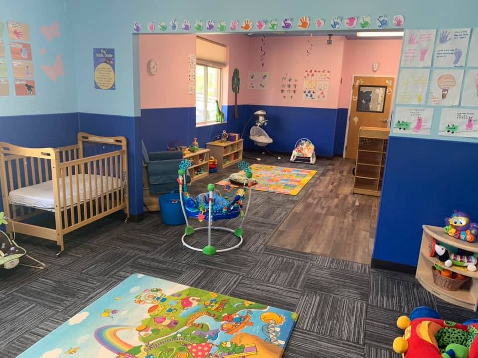 Nursery room with crib, playmats, and baby bouncer