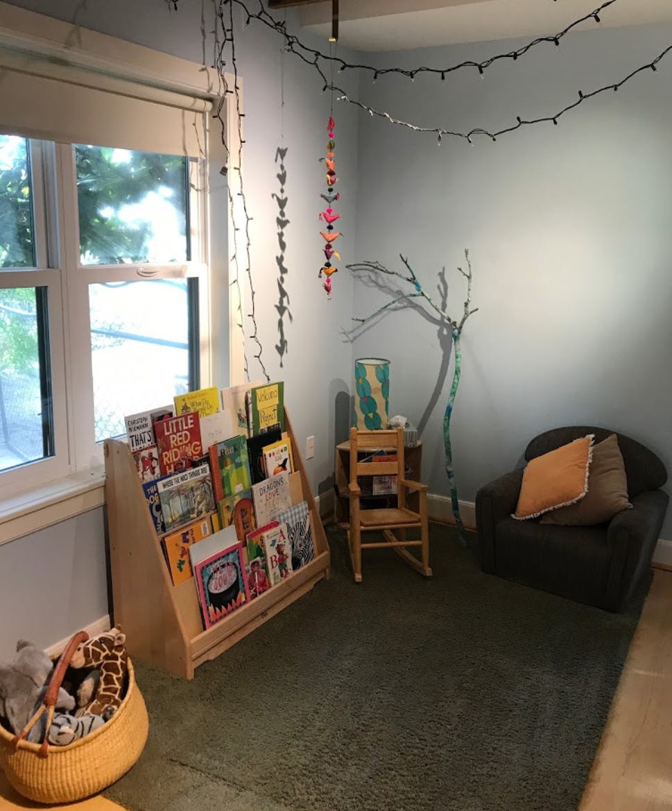 Children's room with book display, small chair, and armchair