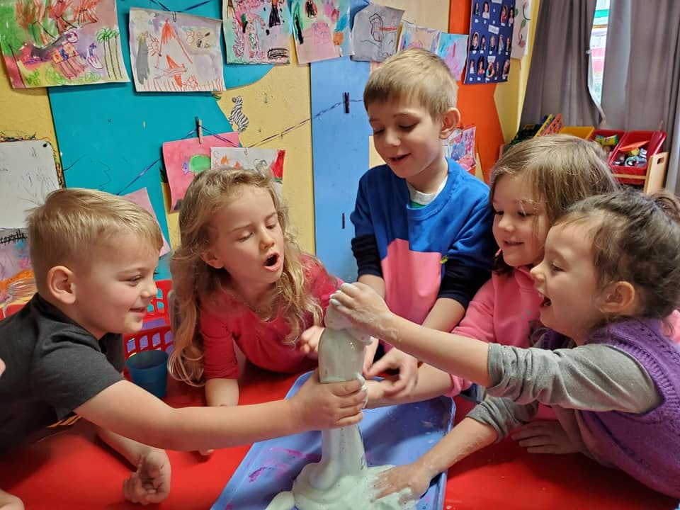 Children playing with slime in a classroom