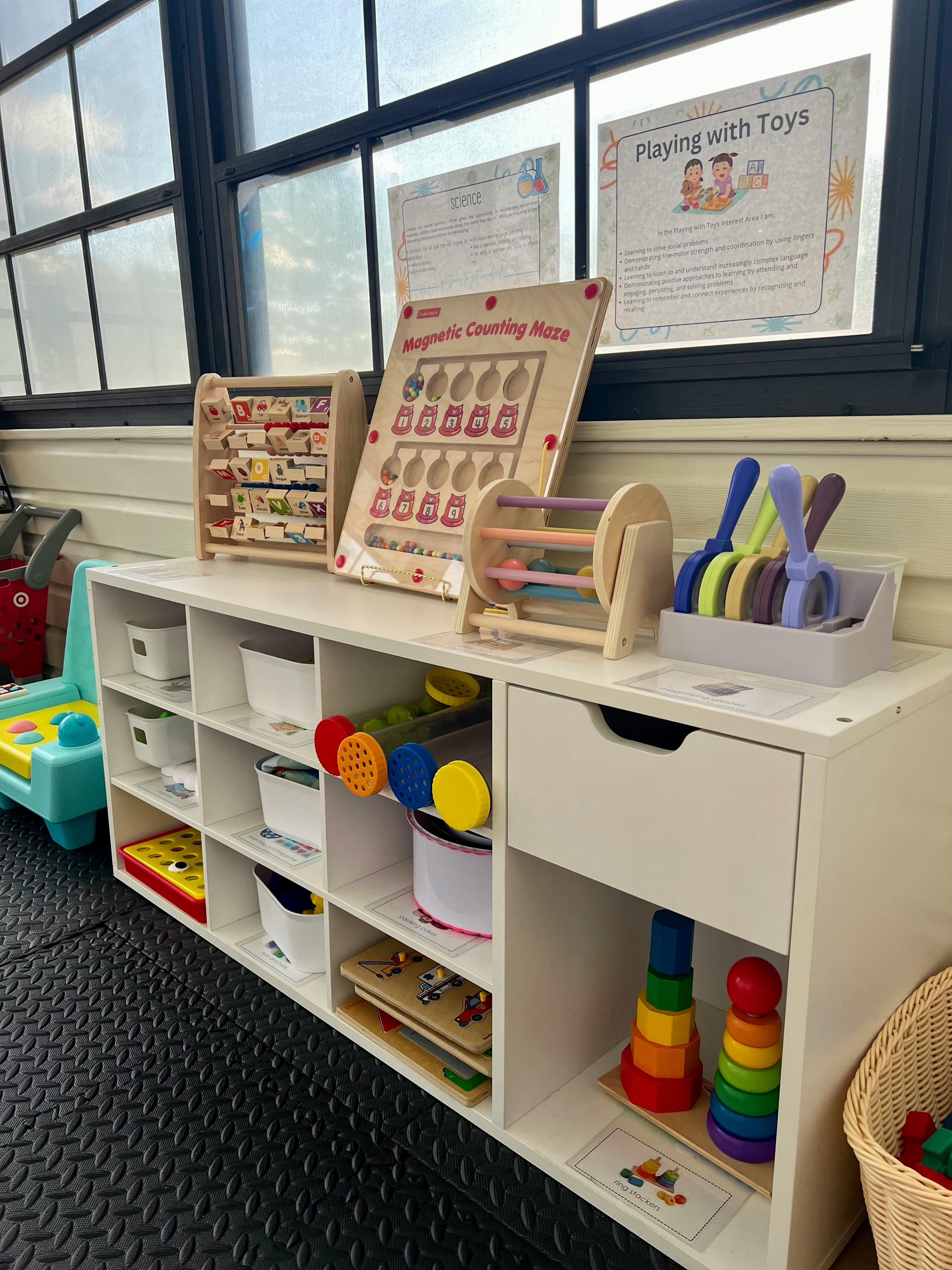 Classroom shelving unit with various toys and learning materials