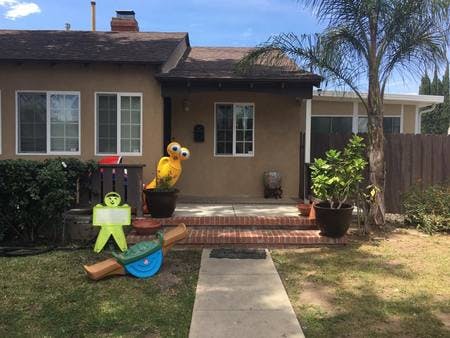 House exterior with a yellow character decoration on the porch