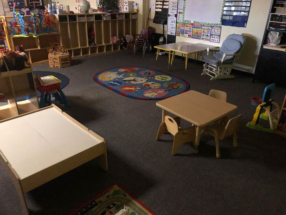 Empty classroom with small tables and chairs