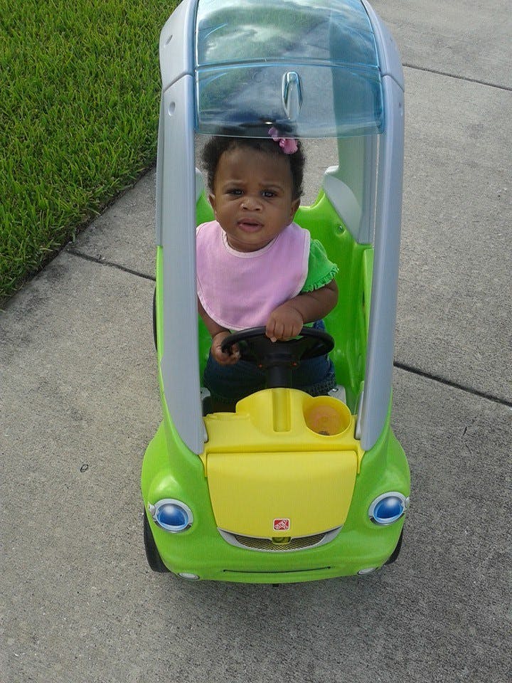 Child in a toy car