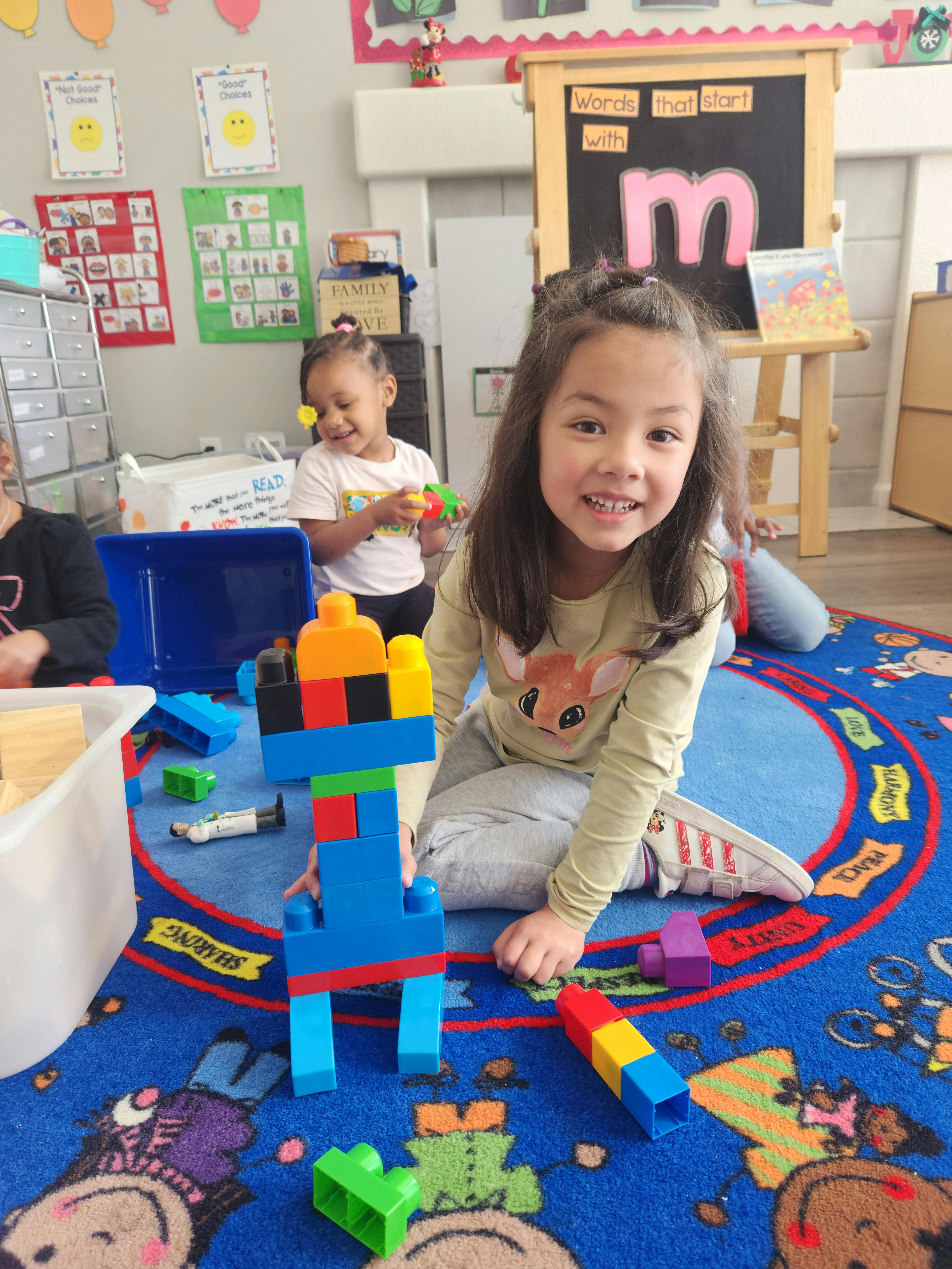 Child playing with building blocks in a classroom