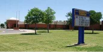 School building with a sign in front