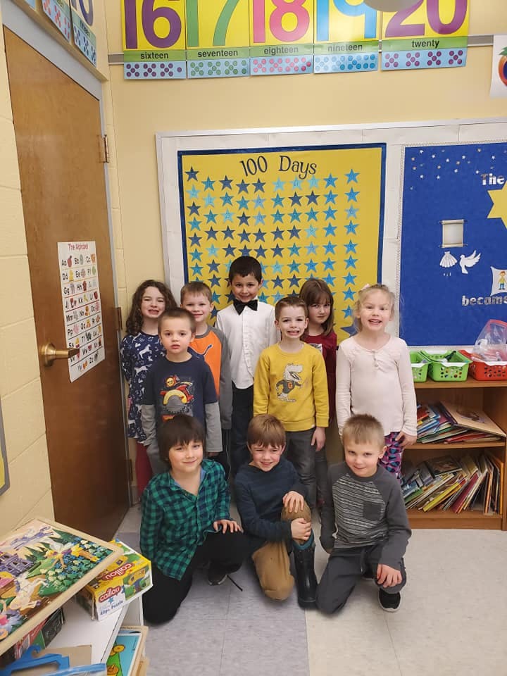 Group of children posing in a classroom