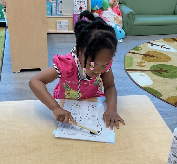 Child brushing teeth on a paper cutout