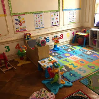 Playroom with colorful alphabet mat and various toys