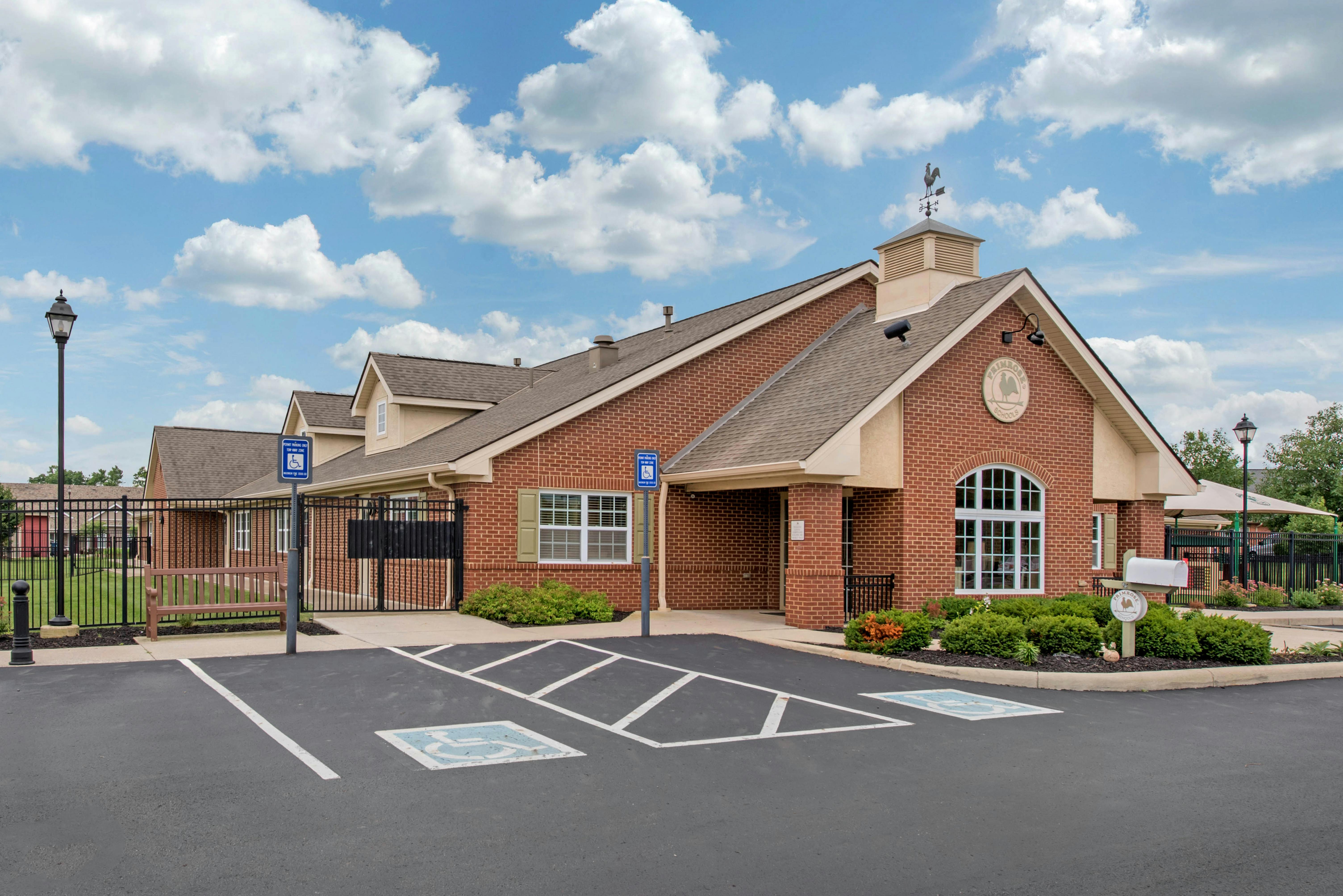 Brick building with a sign that reads "Primrose Schools" on a sunny day