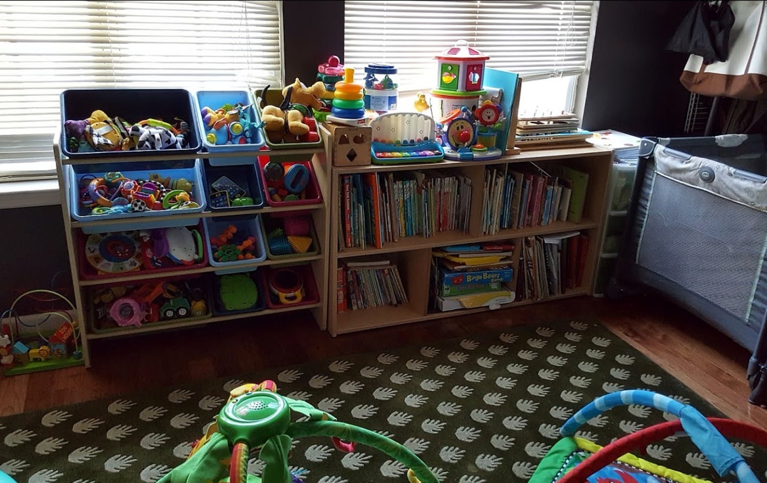 Children's room with toy storage bins and a bookshelf