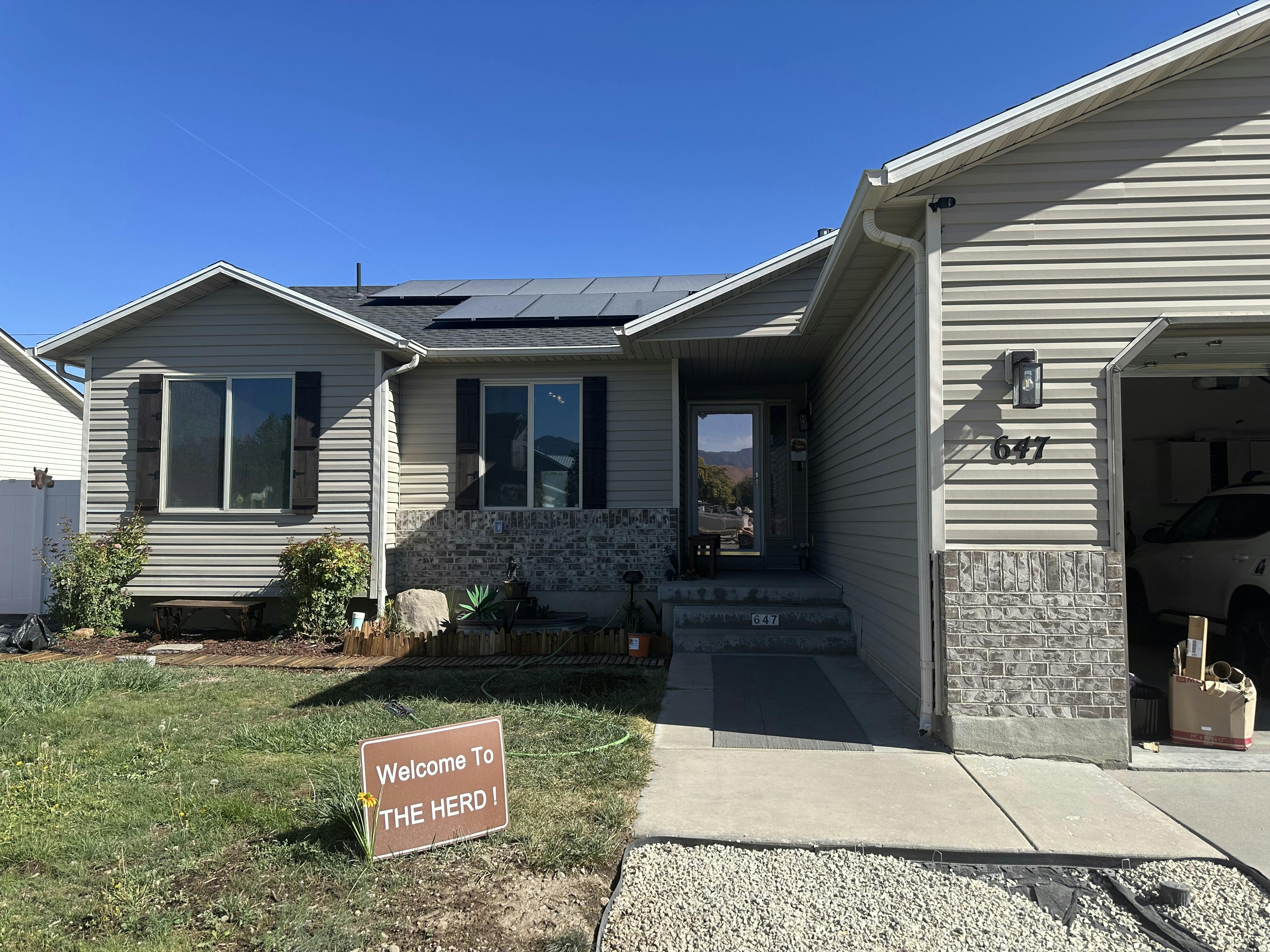House with a sign that says "Welcome to THE HERD"