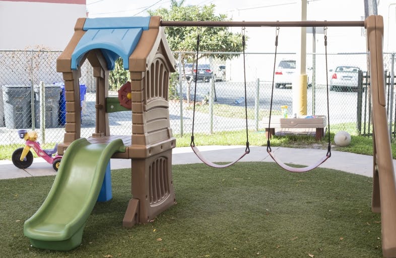 Playground with a slide and two swings
