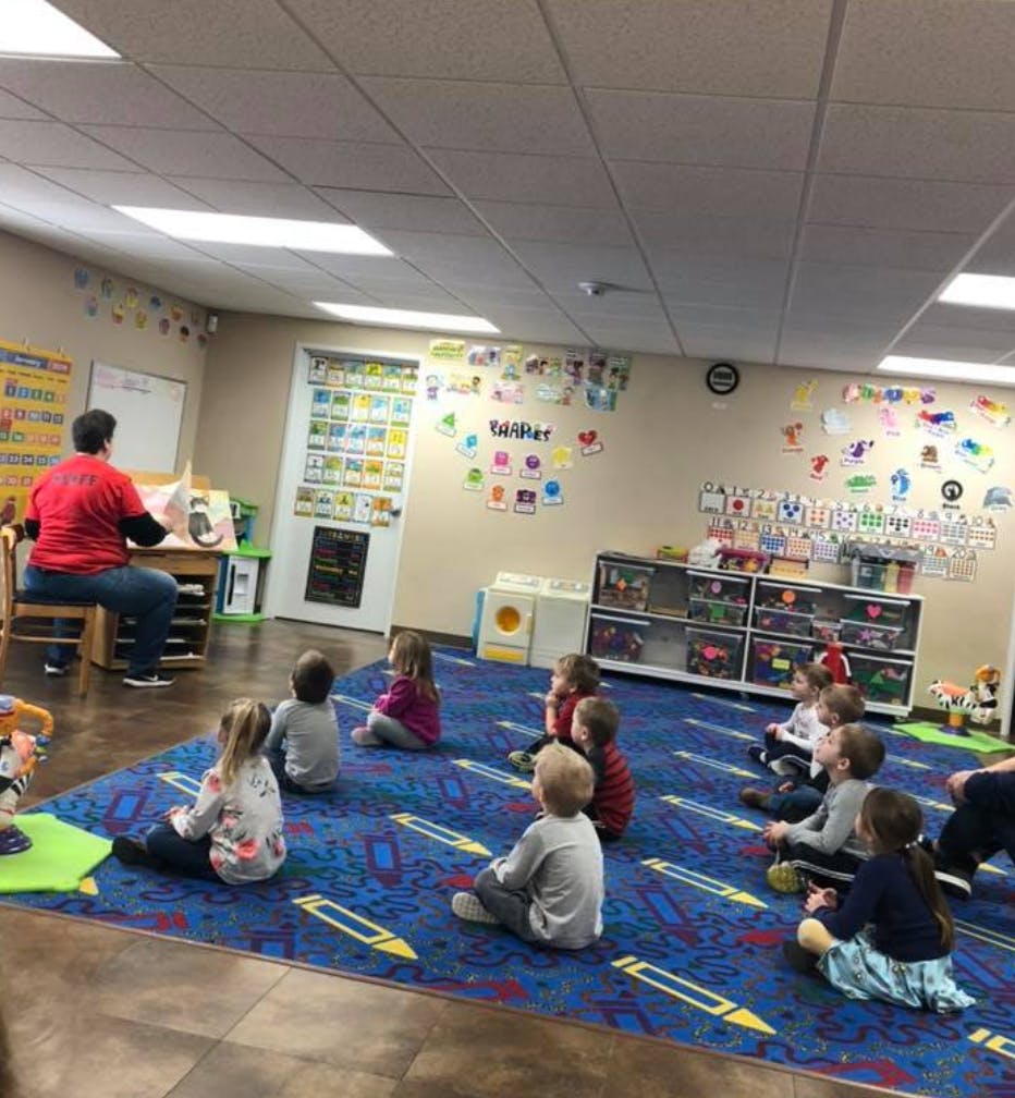 Person reading to children in a classroom