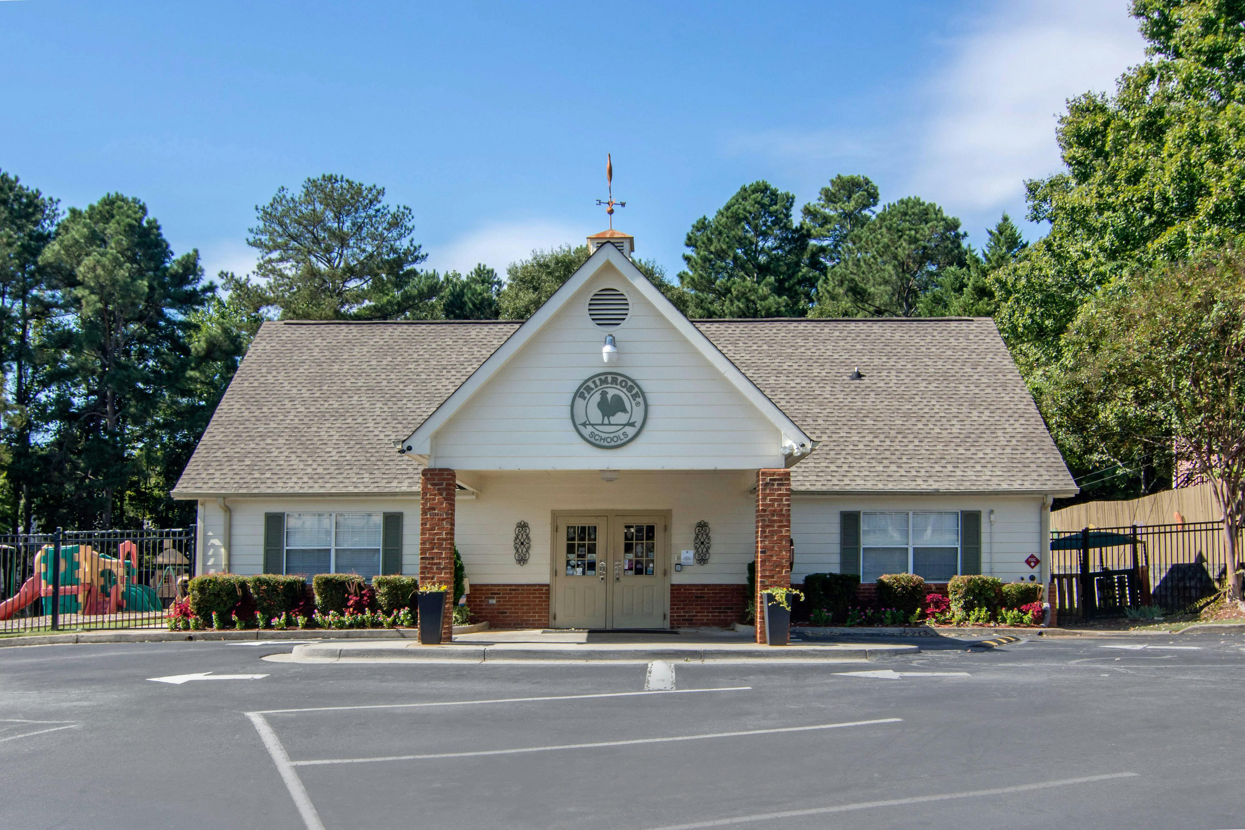 A beige building with a sign that says Primrose Schools