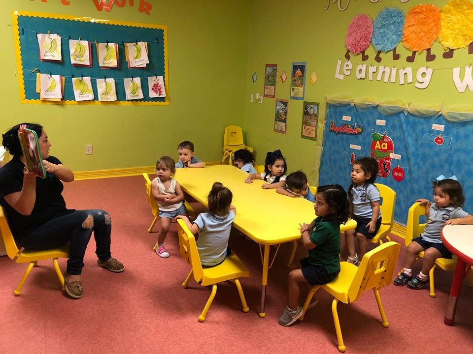 Adult reading to children in a classroom